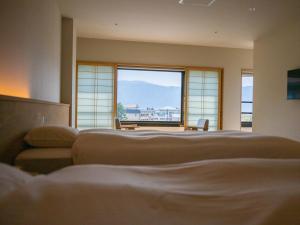 Ένα ή περισσότερα κρεβάτια σε δωμάτιο στο Suhaku