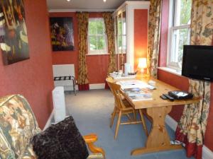 a room with a desk and a table and chairs at Mickley Bed and Breakfast in Mickley