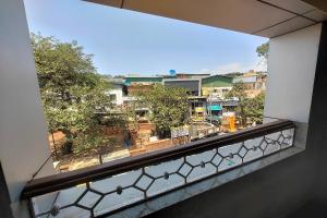 a view of a city from a window at Harmony Inn in Mahabaleshwar