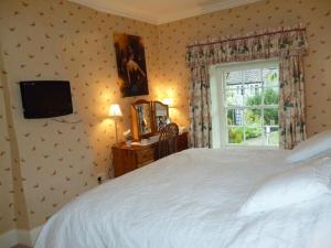 a bedroom with a white bed and a window at Mickley Bed and Breakfast in Mickley