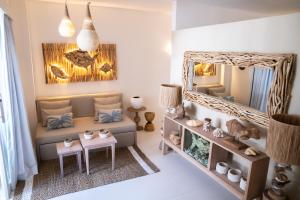 a living room with a couch and a mirror at Antana Hotel in Canggu +19 photos