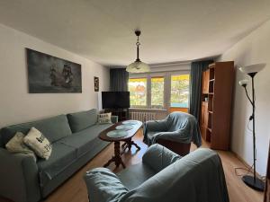 a living room with a couch and a table at Apartament Helanka in Hel