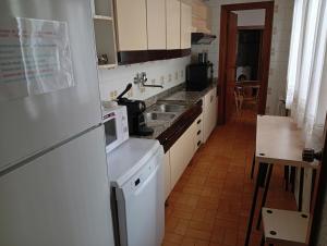 a kitchen with a sink and a microwave at central apartment in Caspe in Caspe