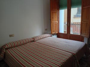 Ένα ή περισσότερα κρεβάτια σε δωμάτιο στο central apartment in Caspe +4 φωτογραφίες