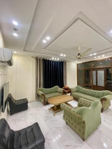 费萨拉巴德Elysian Nest 2BR Apartment Abdullah Gardens的带沙发和桌子的客厅