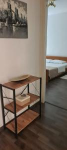 a room with a table with a bed in the background at Coco Apartment in Dobrota