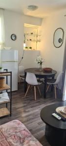 a room with a table and chairs and a kitchen at Coco Apartment in Dobrota