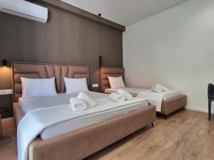 Postel nebo postele na pokoji v ubytování Augusto Rooms