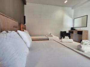 Postel nebo postele na pokoji v ubytování Augusto Rooms