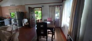 a living room with a table and chairs and a kitchen at Cabañas Rapanui keka in Hanga Roa