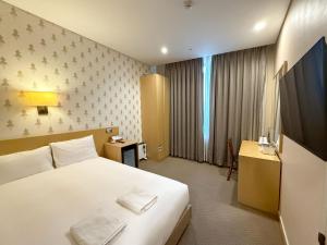 Postel nebo postele na pokoji v ubytování Mohenic Hotel Seoul Myeongdong