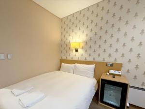 Postel nebo postele na pokoji v ubytování Mohenic Hotel Seoul Myeongdong