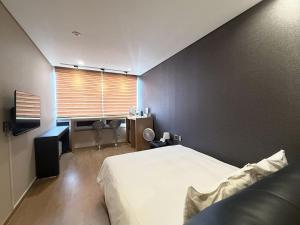 Postel nebo postele na pokoji v ubytování Mohenic Hotel Seoul Myeongdong