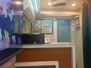 a room with a counter with a tv on it at Chiitajyoti Home Stay in Silchar