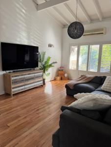 a living room with a large flat screen tv at Brighton Beach Villa Scarborough in Perth