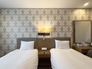 Postel nebo postele na pokoji v ubytování Mohenic Hotel Seoul Myeongdong