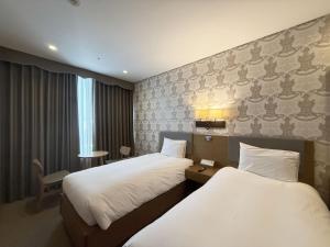 Postel nebo postele na pokoji v ubytování Mohenic Hotel Seoul Myeongdong