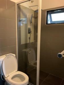 a bathroom with a toilet and a shower at Premelthi Homestay bed and breakfast Mount Lavinia in Watumulla
