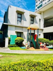 a playground in front of a building at 2 Bedrooms Budget Friendly Condotel in Iloilo City in Iloilo City