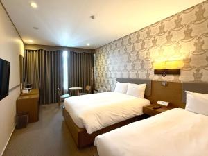 Postel nebo postele na pokoji v ubytování Mohenic Hotel Seoul Myeongdong