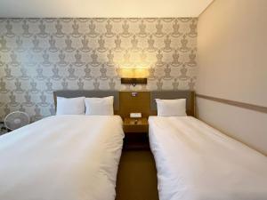 Postel nebo postele na pokoji v ubytování Mohenic Hotel Seoul Myeongdong