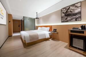 a hotel room with a bed and a fireplace at Guangzhou Baiyun Airport COCO Hotel T2 Terminal Store Canton Fair Free Shuttle Bus in Huadu