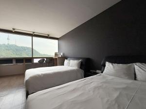 Postel nebo postele na pokoji v ubytování Mohenic Hotel Seoul Myeongdong
