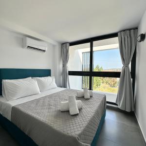 a bedroom with a bed and a large window at Flâneur in Kallithea Halkidikis +117 photos