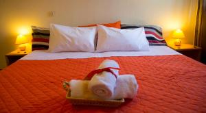 a hotel room with a bed with towels on it at Elia Houses in Koutsounari