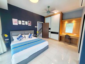 a bedroom with a large bed and a desk in it at Sunday Villa 14 pax with jacuzzi pool in Ulu Melaka