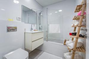 a bathroom with a shower and a toilet and a sink at Eshel Suites Even Israel in Jerusalem +190 photos