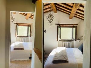 a bedroom with two beds and two windows at Casale Lucciole in Santa Maria Lignano