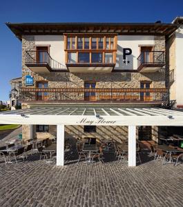 a building with tables and chairs in front of it at Katrapona in Getaria