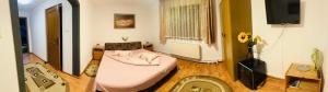 a room with a bed in the middle of a room at Casa BOICO in Gura Humorului
