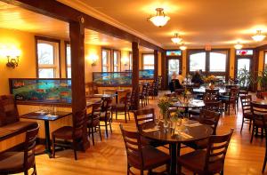 a restaurant with tables and chairs in a room at Heriot Bay Inn in Heriot Bay
