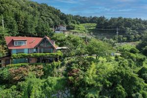 an aerial view of a house in the mountains at Badawiae Tongnamu Pension in Yeosu