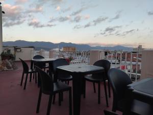 a group of tables and chairs on a balcony at Hotel Shauard in Salta