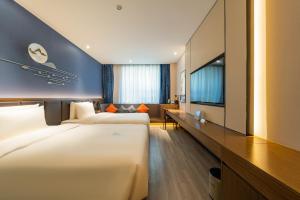 Postel nebo postele na pokoji v ubytování Atour X Hotel Beijing Sanyuan Bridge
