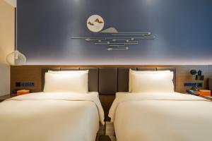 Postel nebo postele na pokoji v ubytování Atour X Hotel Beijing Sanyuan Bridge