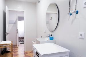 a white bathroom with a sink and a mirror at Altozano la Victoria A 2 hab in Andújar