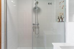 a shower with a glass door next to a sink at Finca Lavinia in Alhaurín el Grande +23 photos