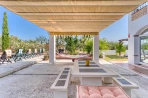 a patio with a picnic table and chairs at Finca Lavinia in Alhaurín el Grande