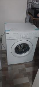 a white washing machine with its door open at Meghri Hotel in Meghri