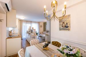 a kitchen and dining room with a table and chairs at Spa Garden Lounge in Mali Lošinj
