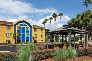 a gazebo in front of a building with palm trees at Days Inn by Wyndham Orange Park/Jacksonville in Orange Park