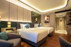Postel nebo postele na pokoji v ubytování FUGO Hotel Banjarmasin + 36 fotografií