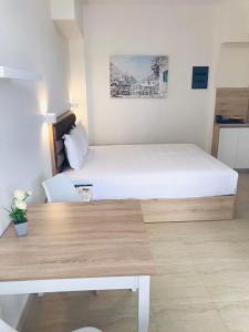 a hotel room with a bed and a desk at Navarino Luxe Suites in Perea