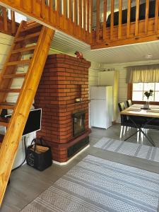 a living room with a brick fireplace and a table at Playa del Finland in Peräseinäjoki +13 photos