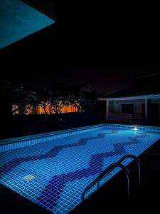 een zwembad dat 's nachts verlicht is bij Tropical 1 Bedroom Pool House In Central Location in Hua Hin