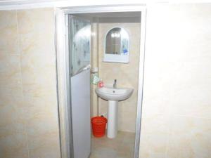 a bathroom with a sink and a mirror and a toilet at Super Star hotel in Derāpur